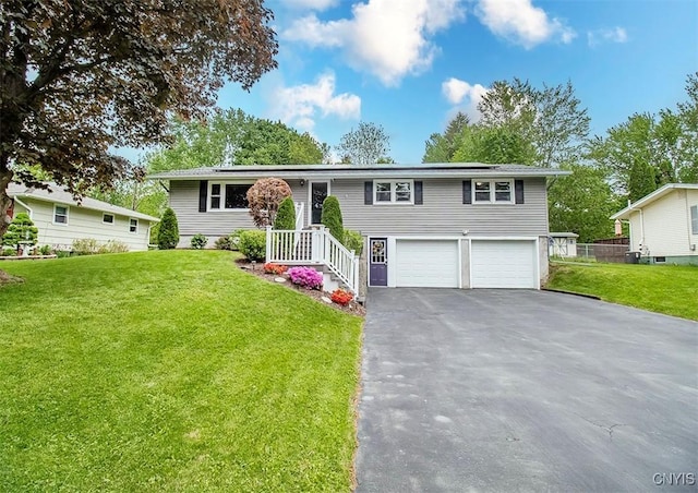 106 Peterson Dr, Camillus, NY 13031 - raised ranch featuring driveway, a garage, roof mounted solar panels, and a front lawn