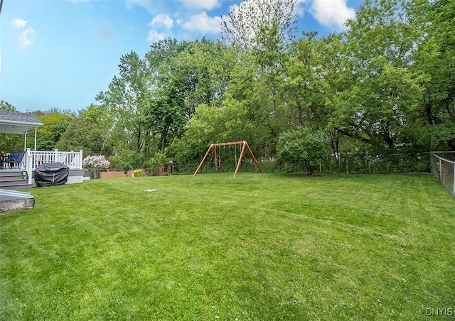 106 Peterson Dr, Camillus, NY 13031 - view of yard featuring a playground, a wooden deck, and view of wooded area
