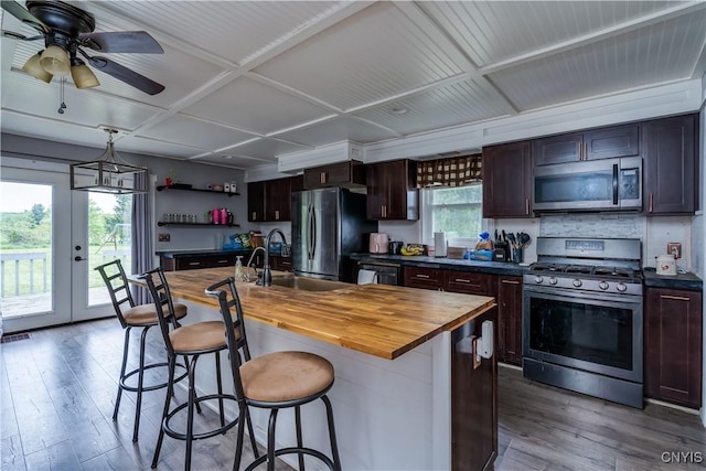 44191 Lime St, Wilna, NY 13665 - kitchen with appliances with stainless steel finishes, butcher block countertops, light wood-style floors, open shelves, and a breakfast bar area