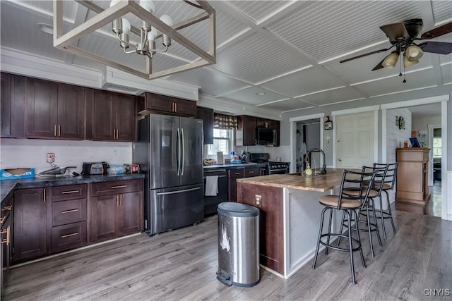 44191 Lime St, Wilna, NY 13665 - kitchen featuring appliances with stainless steel finishes, a chandelier, light wood-style flooring, a kitchen bar, and a ceiling fan