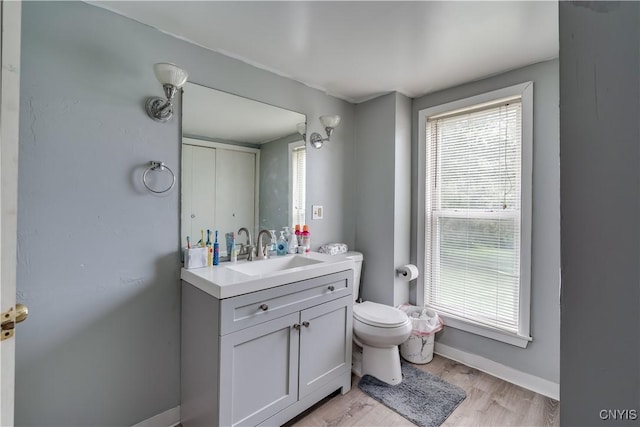 44191 Lime St, Wilna, NY 13665 - bathroom featuring toilet, vanity, wood finished floors, and baseboards