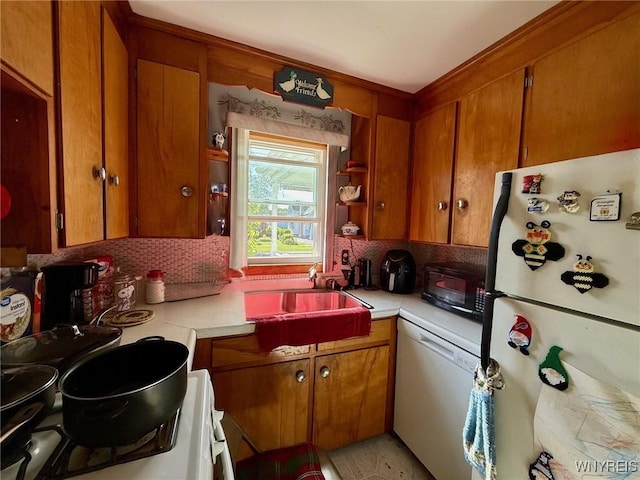 815 91st St, Niagara Falls, NY 14304 - kitchen with white appliances, tasteful backsplash, light countertops, and brown cabinetry