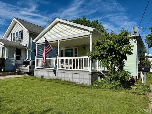815 91st St, Niagara Falls, NY 14304 - view of front of home with covered porch and a front yard
