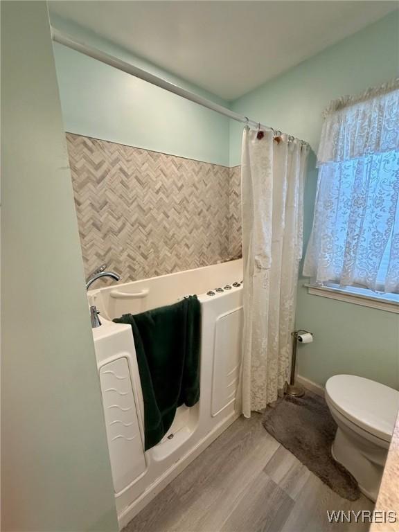 815 91st St, Niagara Falls, NY 14304 - bathroom featuring wood finished floors and toilet