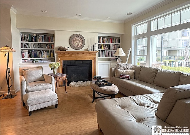 50 Lakeside Dr Unit C103, Ellery, NY 14712 - living area with ornamental molding, built in shelves, wood finished floors, a fireplace with raised hearth, and recessed lighting