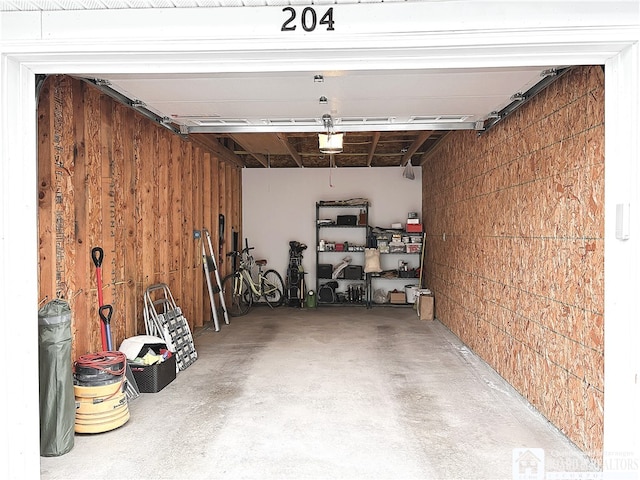 50 Lakeside Dr Unit C103, Ellery, NY 14712 - garage featuring a garage door opener and wooden walls