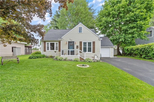 111 Patricia Ln, Cicero, NY 13212 - view of front facade featuring a front lawn, roof with shingles, a detached garage, and driveway
