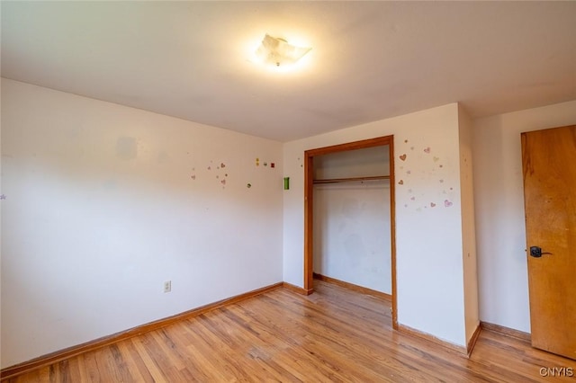7634 Anne Ter, Clay, NY 13212 - unfurnished bedroom with light wood-style flooring, a closet, and baseboards