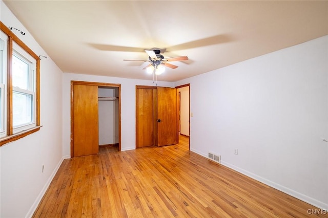 7634 Anne Ter, Clay, NY 13212 - unfurnished bedroom featuring light wood-style flooring, baseboards, a ceiling fan, and multiple closets