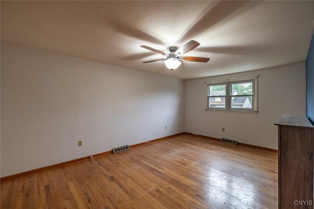7634 Anne Ter, Clay, NY 13212 - unfurnished room with ceiling fan, baseboards, and light wood-style floors