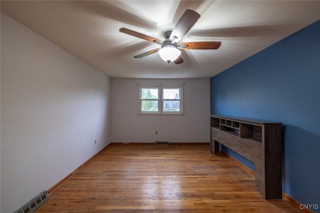 7634 Anne Ter, Clay, NY 13212 - unfurnished living room with ceiling fan, wood finished floors, and baseboards