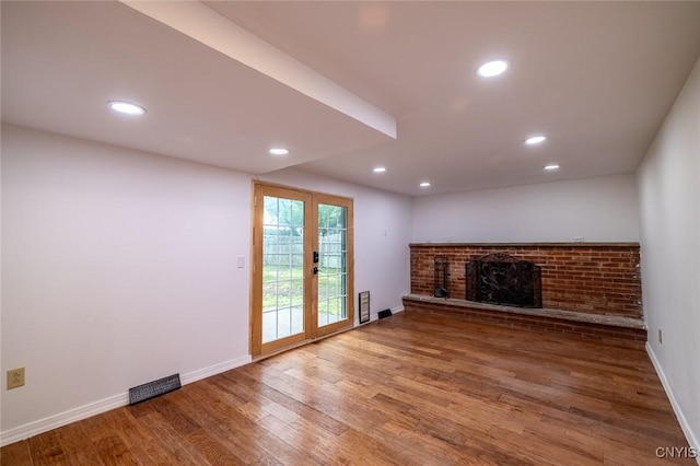 7634 Anne Ter, Clay, NY 13212 - unfurnished living room with a fireplace, wood finished floors, baseboards, recessed lighting, and french doors