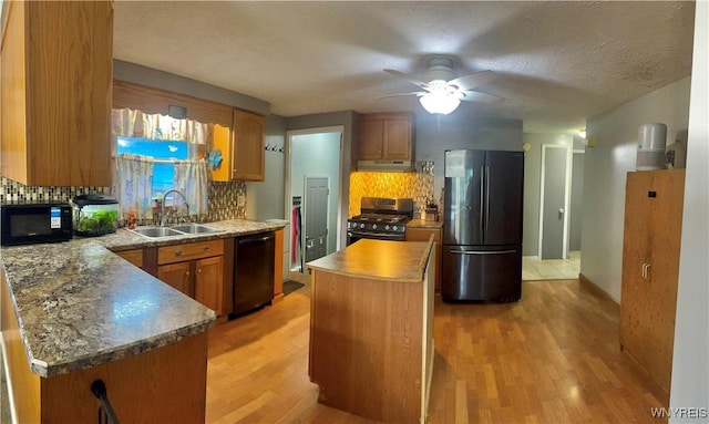 9357 Steffi Dr, Evans, NY 14006 - kitchen with freestanding refrigerator, a sink, dishwasher, stainless steel gas range oven, and under cabinet range hood