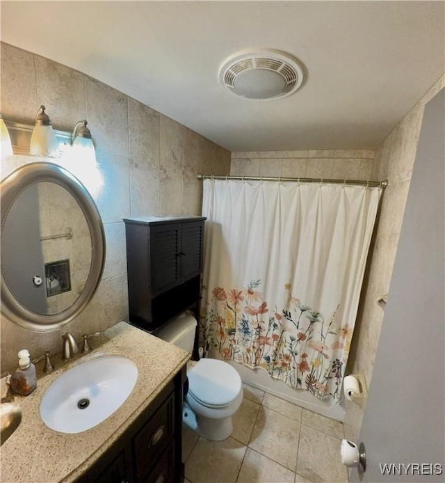 9357 Steffi Dr, Evans, NY 14006 - full bath featuring vanity, tile patterned flooring, tile walls, toilet, and shower / tub combo