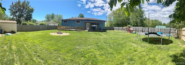 9357 Steffi Dr, Evans, NY 14006 - view of yard featuring a trampoline, an outdoor fire pit, and a wooden deck