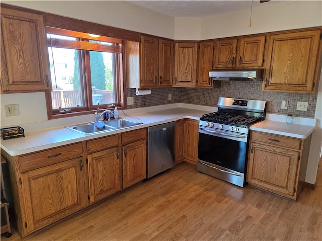 70 Crestway Ln, Greece, NY 14612 - kitchen featuring appliances with stainless steel finishes, a sink, under cabinet range hood, and light countertops