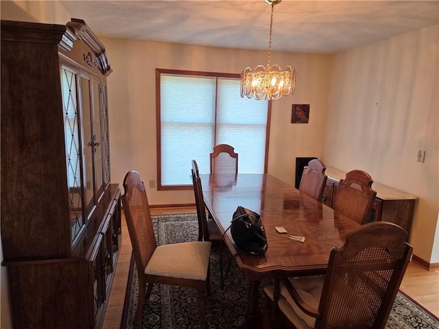 70 Crestway Ln, Greece, NY 14612 - dining area with a chandelier, light wood-type flooring, and baseboards