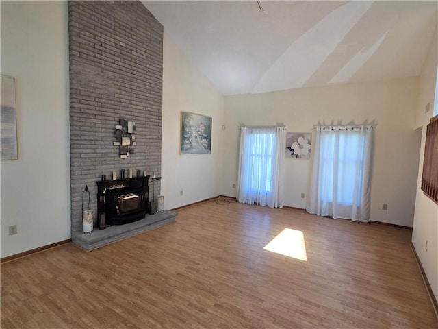 70 Crestway Ln, Greece, NY 14612 - unfurnished living room with high vaulted ceiling, wood finished floors, and baseboards