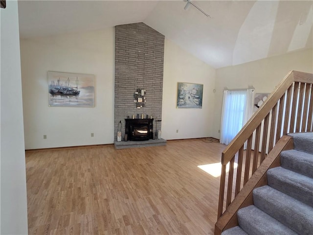 70 Crestway Ln, Greece, NY 14612 - living room featuring high vaulted ceiling, wood finished floors, stairway, and baseboards