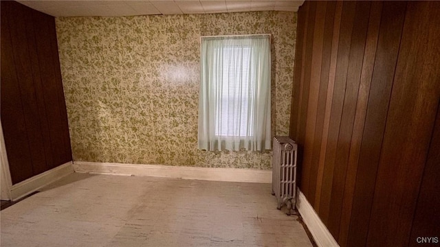 318 Boyden St, Syracuse, NY 13203 - empty room featuring wallpapered walls, radiator heating unit, baseboards, and plenty of natural light