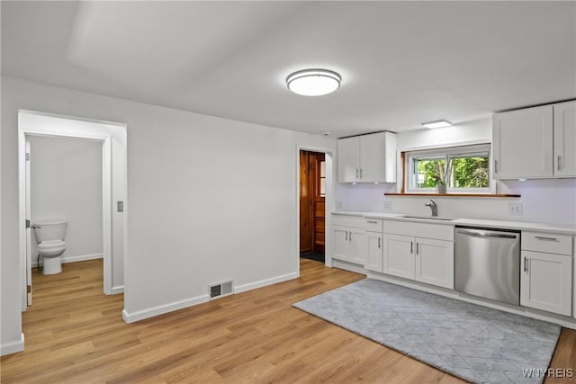 5302 William St, Lancaster, NY 14086 - kitchen featuring dishwasher, a sink, light wood finished floors, and light countertops