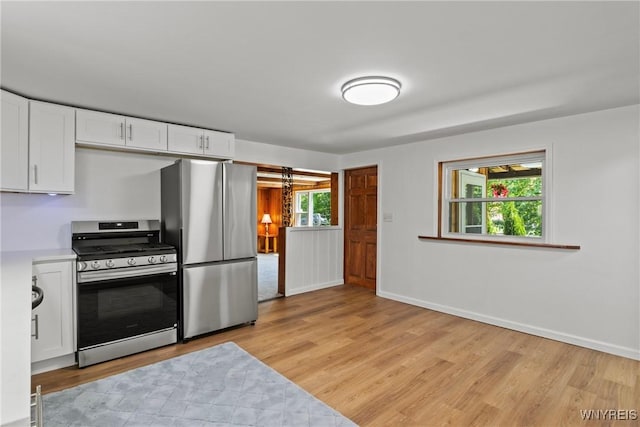 5302 William St, Lancaster, NY 14086 - kitchen featuring stainless steel appliances, light wood-style flooring, white cabinetry, and light countertops