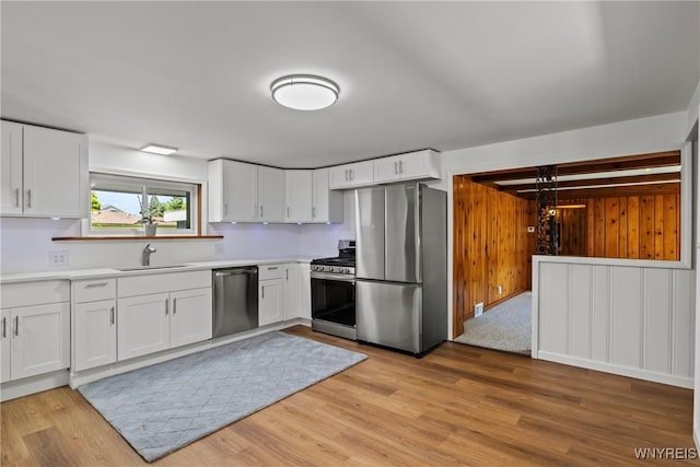 5302 William St, Lancaster, NY 14086 - kitchen featuring stainless steel appliances, a sink, white cabinets, and light countertops