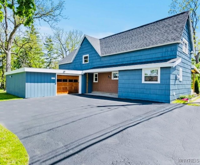 5302 William St, Lancaster, NY 14086 - view of front of property featuring a shingled roof, a garage, and driveway