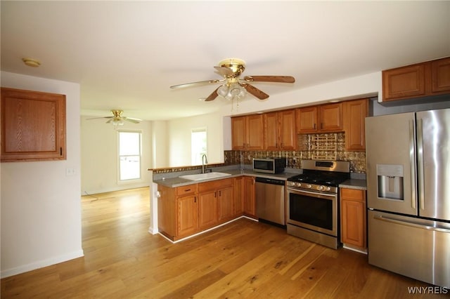 21 Maple St, Evans, NY 14006 - kitchen featuring appliances with stainless steel finishes, a ceiling fan, tasteful backsplash, and light wood-type flooring