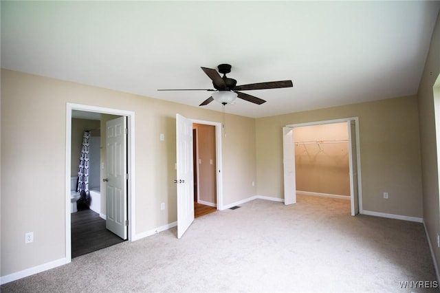 21 Maple St, Evans, NY 14006 - unfurnished bedroom featuring carpet floors, a spacious closet, a closet, a ceiling fan, and ensuite bath