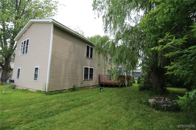 21 Maple St, Evans, NY 14006 - view of side of property featuring a lawn and a deck