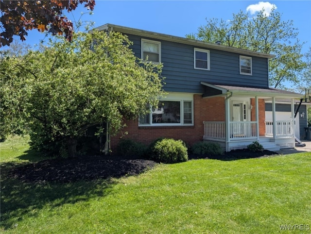 343 Carrollwood Dr, Porter, NY 14174 - view of front facade featuring a porch, a front lawn, and brick siding