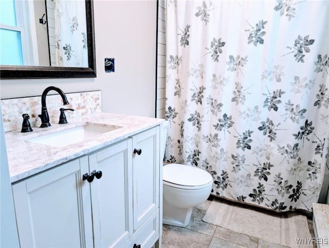 343 Carrollwood Dr, Porter, NY 14174 - full bathroom featuring vanity, toilet, backsplash, and a shower with curtain