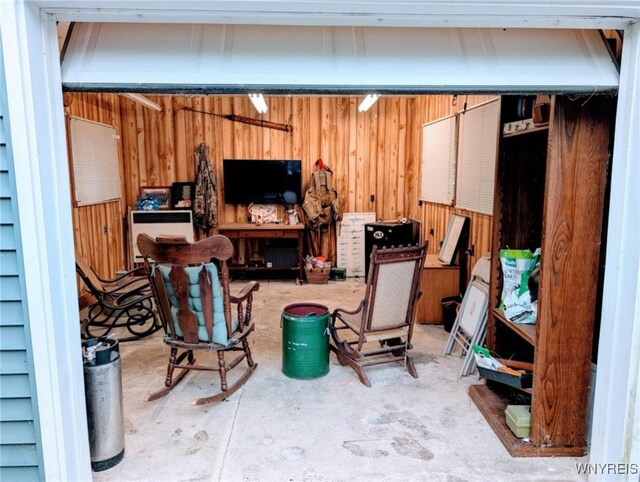 343 Carrollwood Dr, Porter, NY 14174 - living area with concrete flooring and wood walls