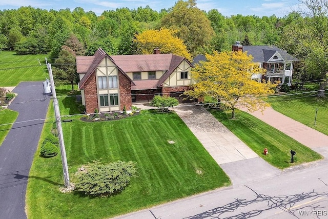 2227 W River Rd, Grand Island, NY 14072 - view of front of home featuring driveway, a front lawn, and brick siding