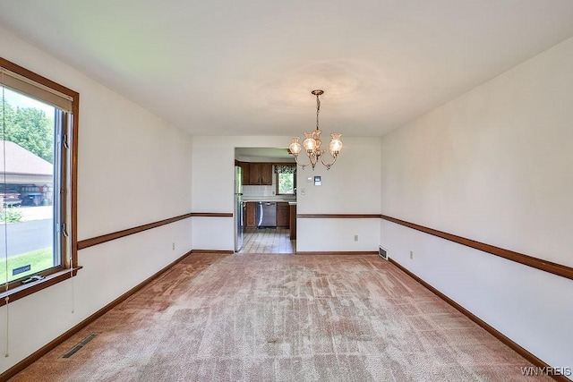 2227 W River Rd, Grand Island, NY 14072 - unfurnished dining area with a chandelier, light colored carpet, and baseboards