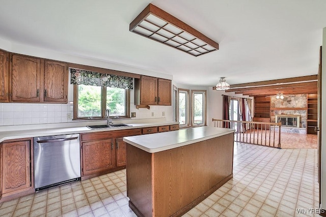 2227 W River Rd, Grand Island, NY 14072 - kitchen with dishwasher, a sink, light countertops, a center island, and light floors