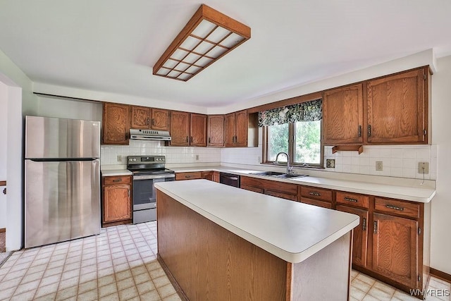2227 W River Rd, Grand Island, NY 14072 - kitchen with appliances with stainless steel finishes, a sink, under cabinet range hood, and light countertops