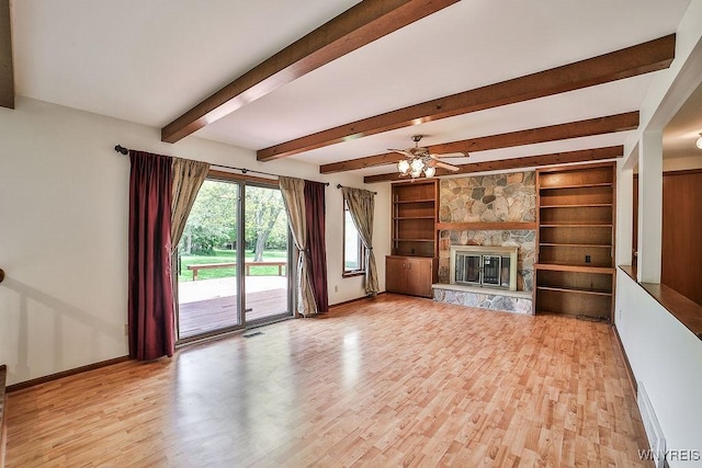 2227 W River Rd, Grand Island, NY 14072 - unfurnished living room with light wood-style flooring, baseboards, a stone fireplace, beamed ceiling, and ceiling fan