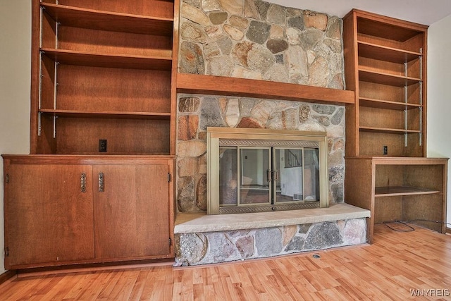 2227 W River Rd, Grand Island, NY 14072 - detailed view of a stone fireplace and wood finished floors