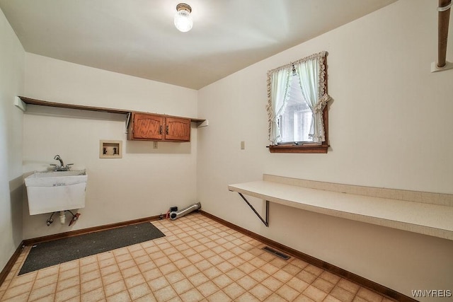 2227 W River Rd, Grand Island, NY 14072 - washroom featuring light floors, cabinet space, baseboards, and hookup for a washing machine