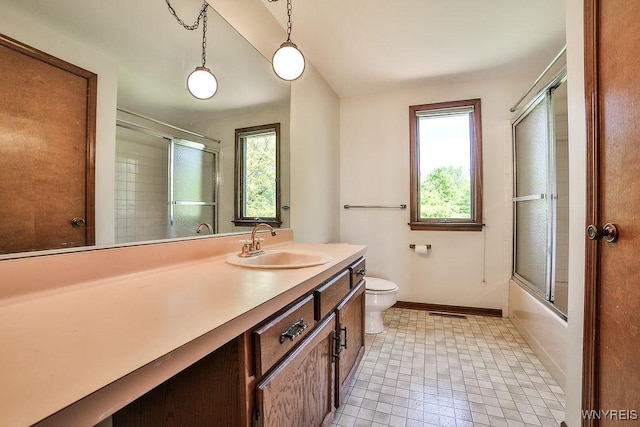 2227 W River Rd, Grand Island, NY 14072 - bathroom featuring vanity, baseboards, toilet, and combined bath / shower with glass door