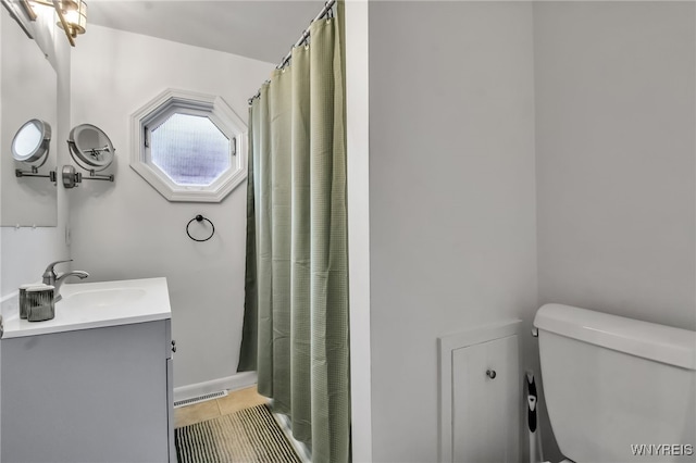 5870 Goodrich Rd, Clarence, NY 14032 - full bath featuring vanity, toilet, tile patterned flooring, and curtained shower