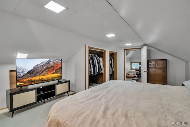5870 Goodrich Rd, Clarence, NY 14032 - bedroom featuring a walk in closet, lofted ceiling, a closet, and carpet flooring