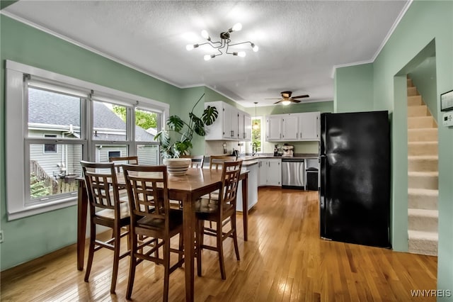 5870 Goodrich Rd, Clarence, NY 14032 - dining area featuring ornamental molding, light wood-style floors, stairway, healthy amount of natural light, and a ceiling fan