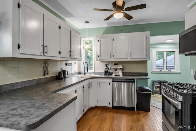 5870 Goodrich Rd, Clarence, NY 14032 - kitchen with appliances with stainless steel finishes, a sink, dark countertops, and healthy amount of natural light