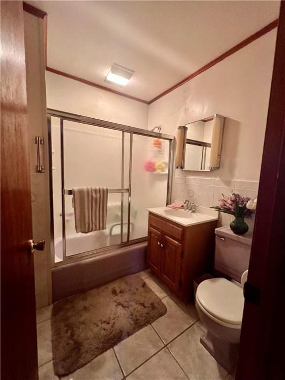 8 Birch St, Oneonta-City, NY 13820 - bathroom featuring crown molding, vanity, toilet, bath / shower combo with glass door, and tile patterned floors