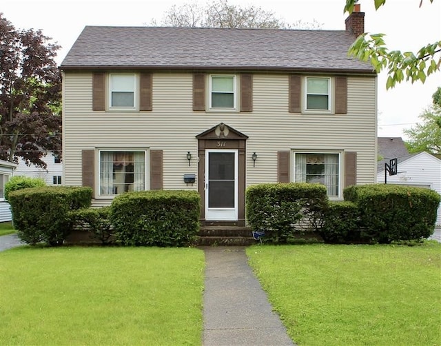 311 N Rogers Pkwy W, Irondequoit, NY 14617 - colonial home featuring a chimney, a front lawn, and entry steps
