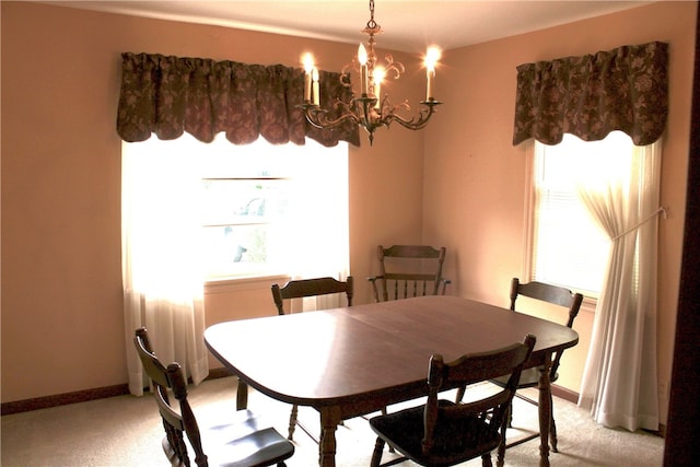 311 N Rogers Pkwy W, Irondequoit, NY 14617 - dining room featuring light colored carpet, a chandelier, and baseboards