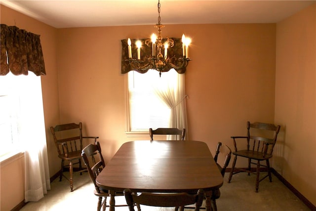 311 N Rogers Pkwy W, Irondequoit, NY 14617 - dining room with light carpet, a chandelier, and baseboards